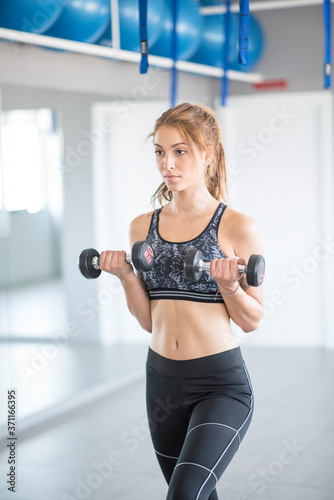 Pretty woman training weights in gym