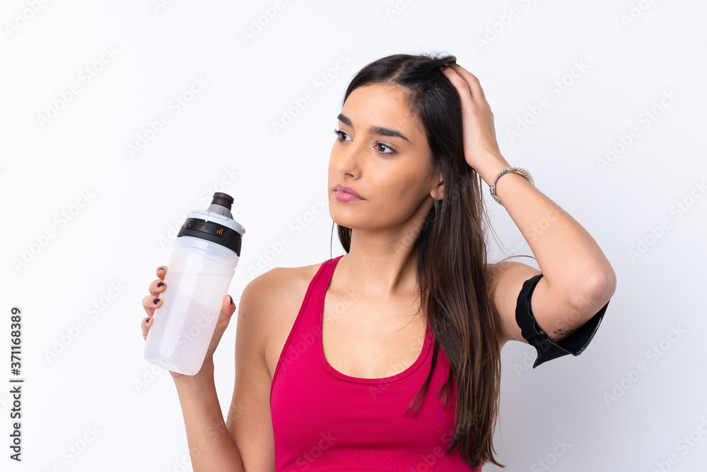 Young sport brunette woman over isolated white background with sports water bottle Young sport brunette woman over isolated white background with sports water bottle