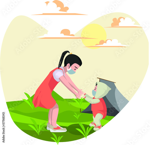A girl playing with her little brother at yard while using medical mask