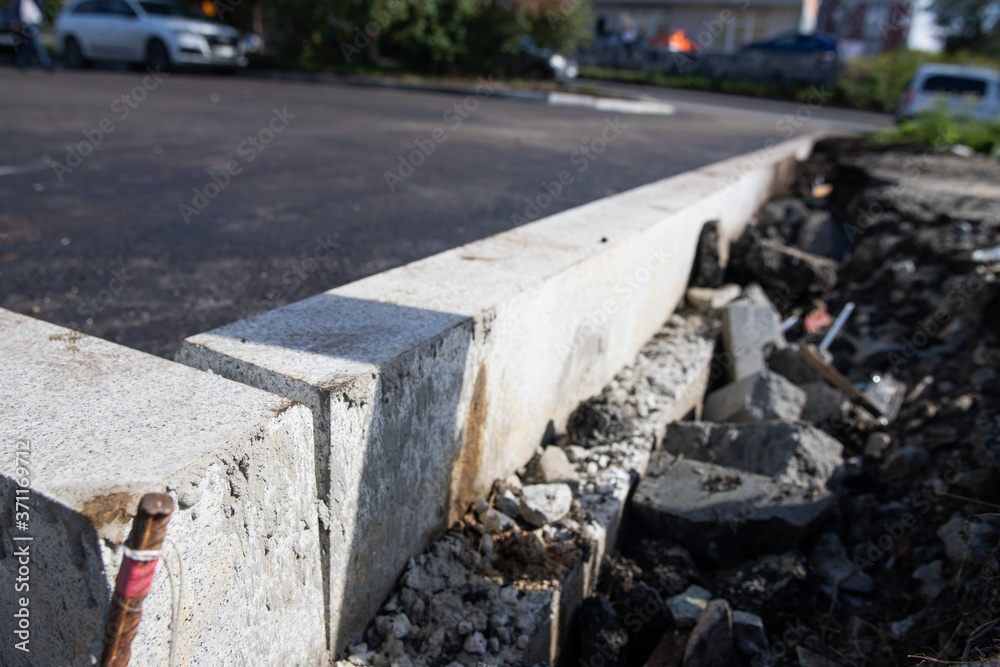 Reconstruction of the sidewalk and replacement of old curbs. Construction zone