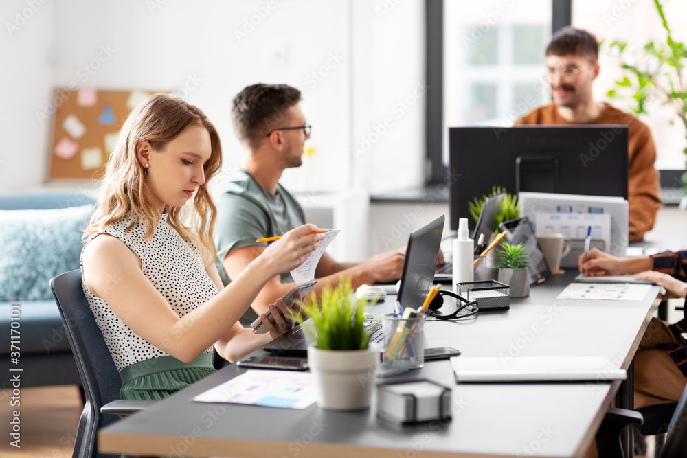 business, people and corporate concept - team of startuppers or ui designers working at office business, people and corporate concept - team of startuppers or ui designers working at office