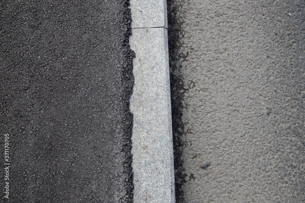 Fototapeta premium New asphalt on the sidewalk, renovation completed