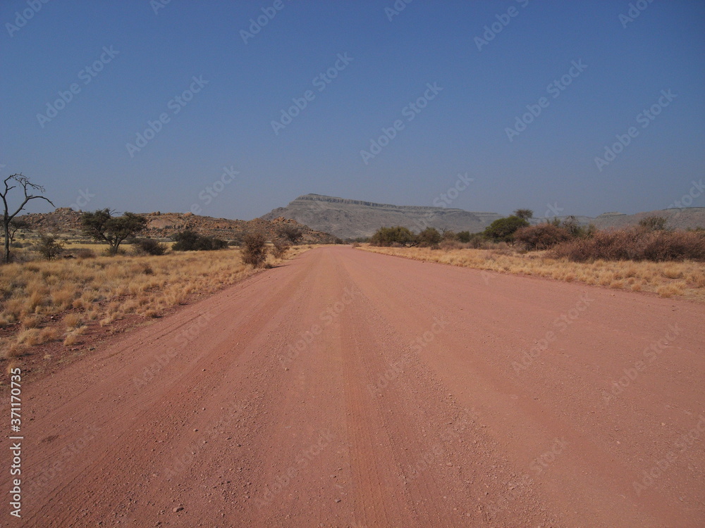 red road in desert in Africa