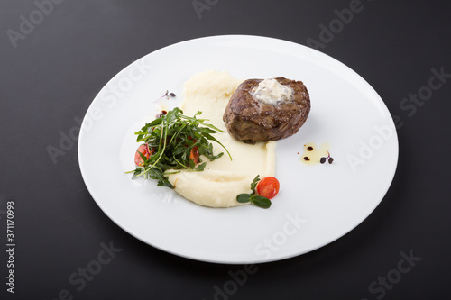 Fried beef steak served with mashed potatoes