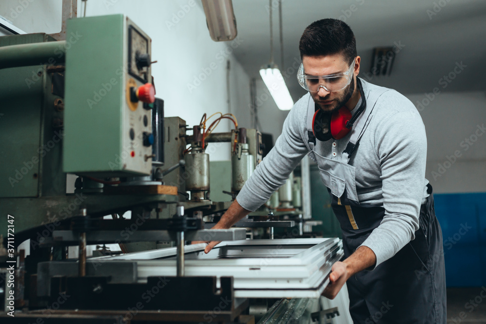 PVC industry worker making PVC frames for windows and doors Stock Photo