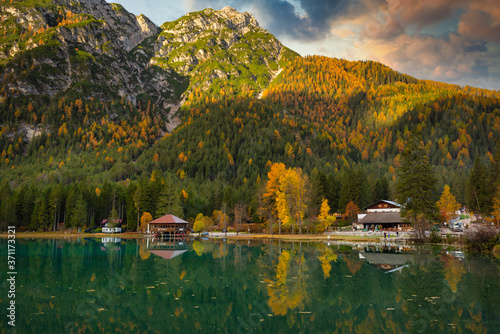 Dolomites mountains with reflection in Lago di Dobbiaca lake at sunrise. Italy