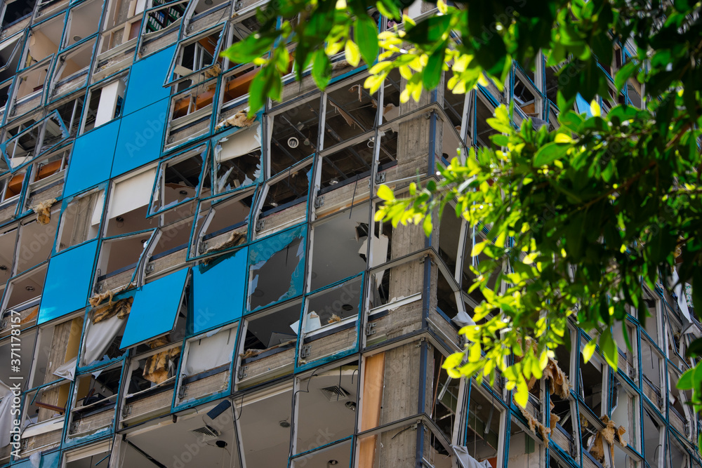 Fototapeta premium facade of an office building damaged by the impact of an explosion