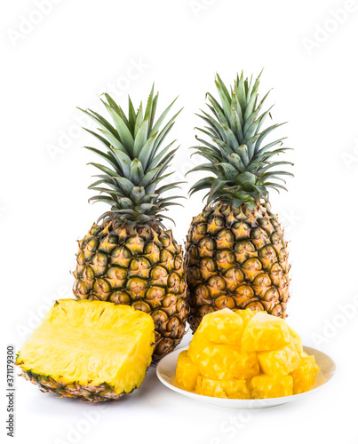Sliced pineapple on a white plate, it is a sweet and juicy fruit.