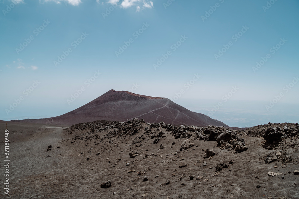 Hikers and tourists walking on black sand Silvestri Craters near Mount Etna - Sicily, Italy