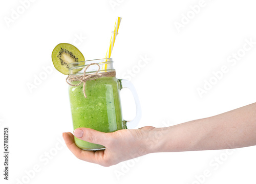 Green summer smoothie in female hand isolated on white
