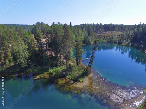 Blue lakes in a coniferous forest. Parashikimi lake, Komi Republic, Russia.