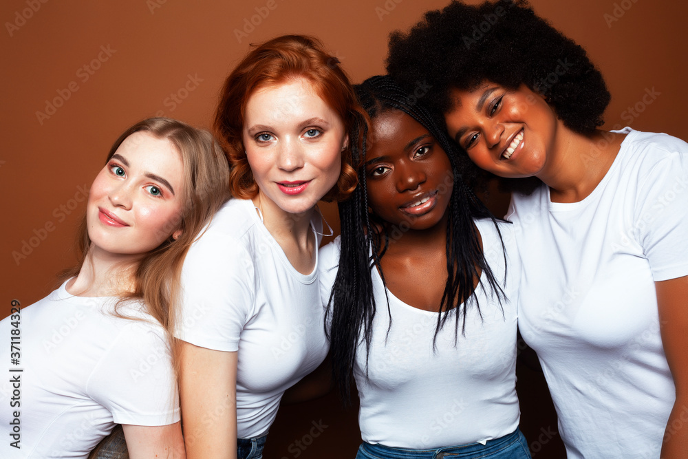 Obraz premium young pretty caucasian, afro, scandinavian woman posing cheerful together on brown background, lifestyle diverse nationality people concept