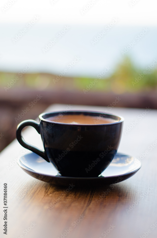 coffee cup on wooden table, black color
coffee cup on wooden table, black color