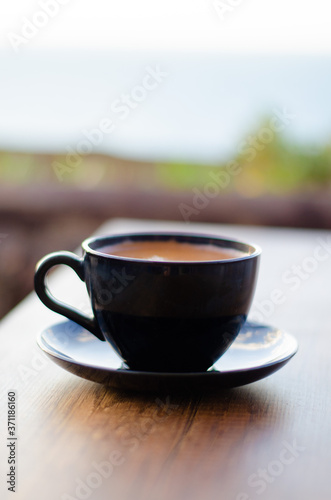 coffee cup on wooden table, black color 