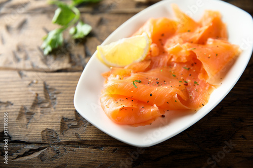 Homemade smoked salmon with lemon photo