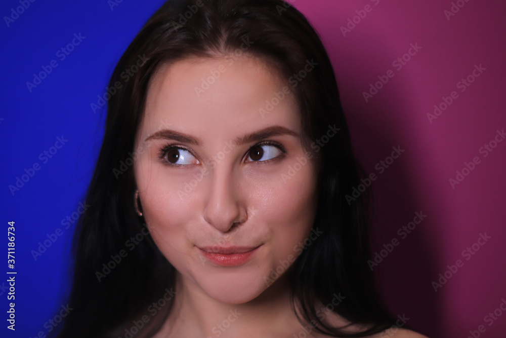 emotional portrait of a brunette girl on a pink-blue background emotional portrait of a brunette girl on a pink-blue background