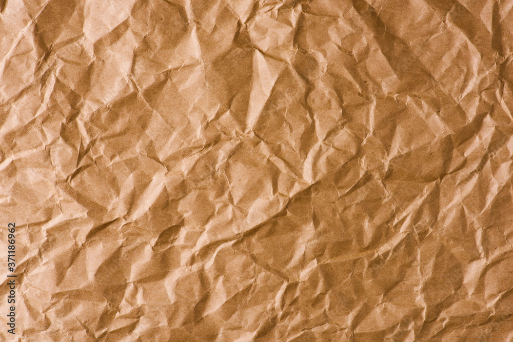 Fototapeta premium brown crumpled Kraft paper background. 