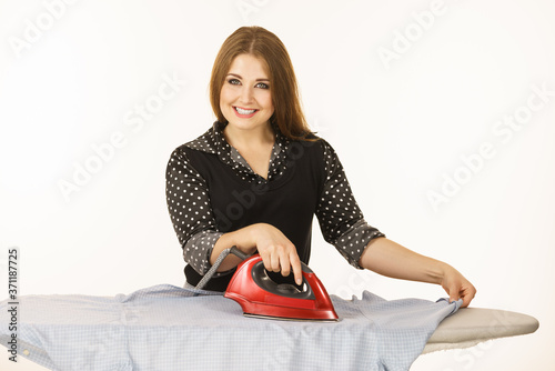 Happy woman doing ironing