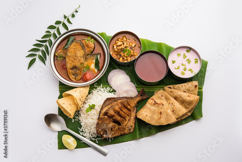 Indian Fish Platter or seafood Thali served in a steel plate or over banana leaf photo