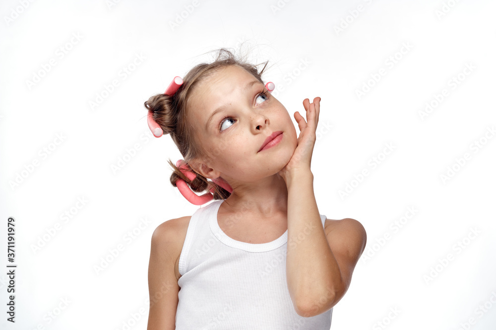 a girl in a white T-shirt swirled curlers hairstyle for hair care light background a girl in a white T-shirt swirled curlers hairstyle for hair care light background