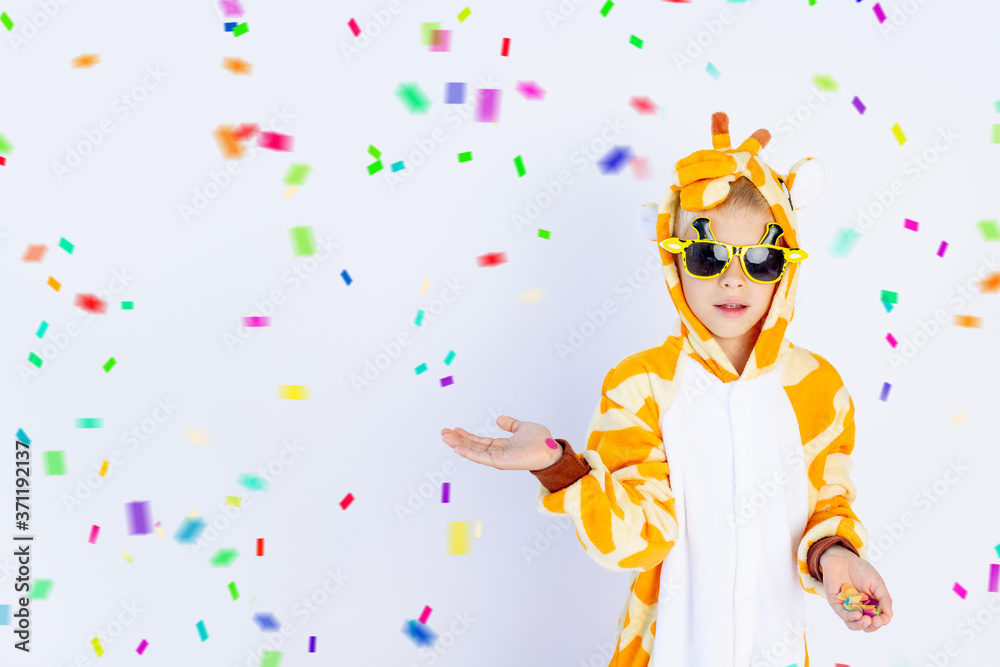 a cheerful boy in a bright orange giraffe costume holds his hand on a white isolated background, space for text a cheerful boy in a bright orange giraffe costume holds his hand on a white isolated background, space for text