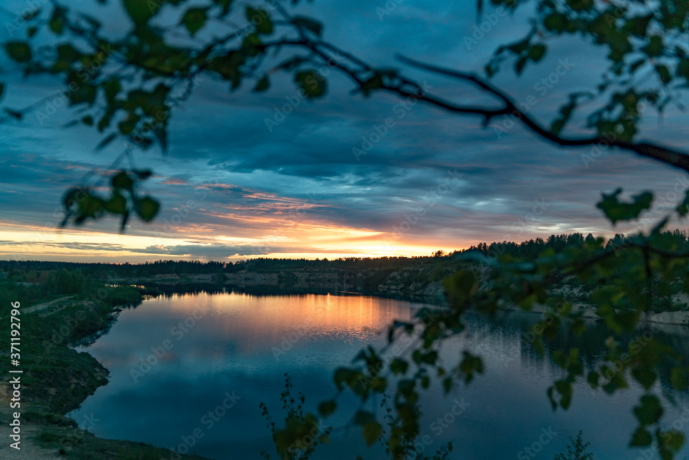 Sunset over a large lake in nature in summer.