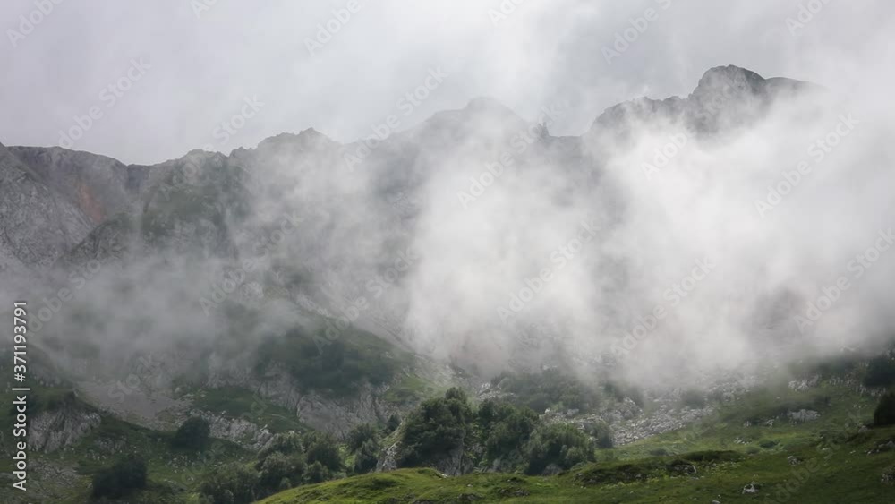Clouds in the mountains. The fog is moving rapidly through the mountain valley Clouds in the mountains. The fog is moving rapidly through the mountain valley