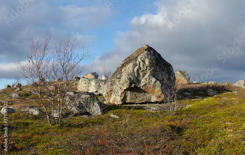 Autumn tundra, huge stones, storm clouds, moss.