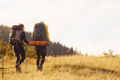 Fototapeta Naklejka Na Ścianę i Meble -  Cute young couple. Majestic Carpathian Mountains. Beautiful landscape of untouched nature