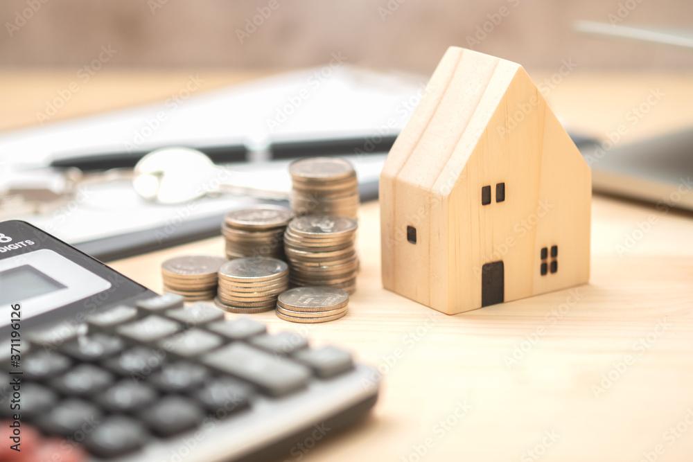 Wooden house model with coins or real estate concept. Real estate broker. insurance or loan real estate. business house investment idea. Wooden house model with coins or real estate concept. Real estate broker. insurance or loan real estate. business house investment idea.