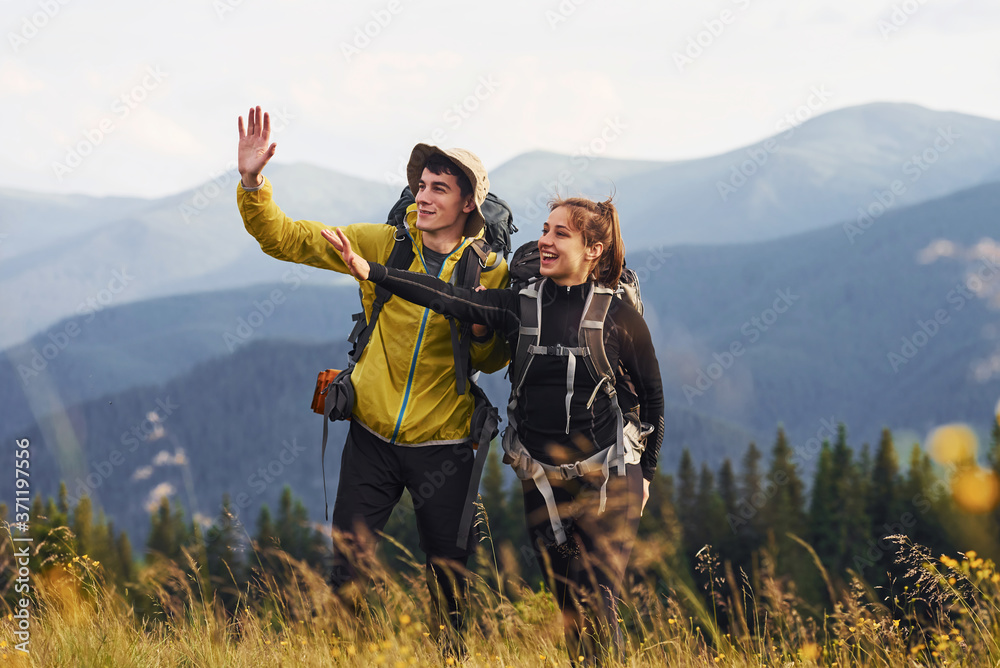 Beautiful young people travel together. Majestic Carpathian Mountains. Beautiful landscape of untouched nature