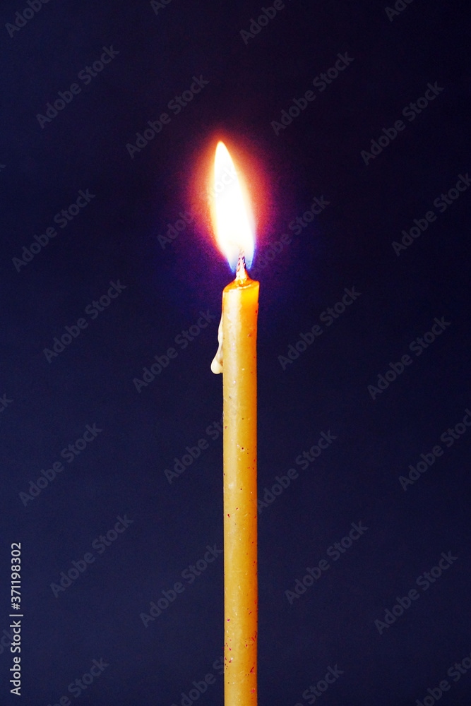 burning wax candle close up on dark background burning wax candle close up on dark background