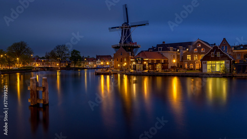 Holland landscape of flowers, tulips and windmills at night