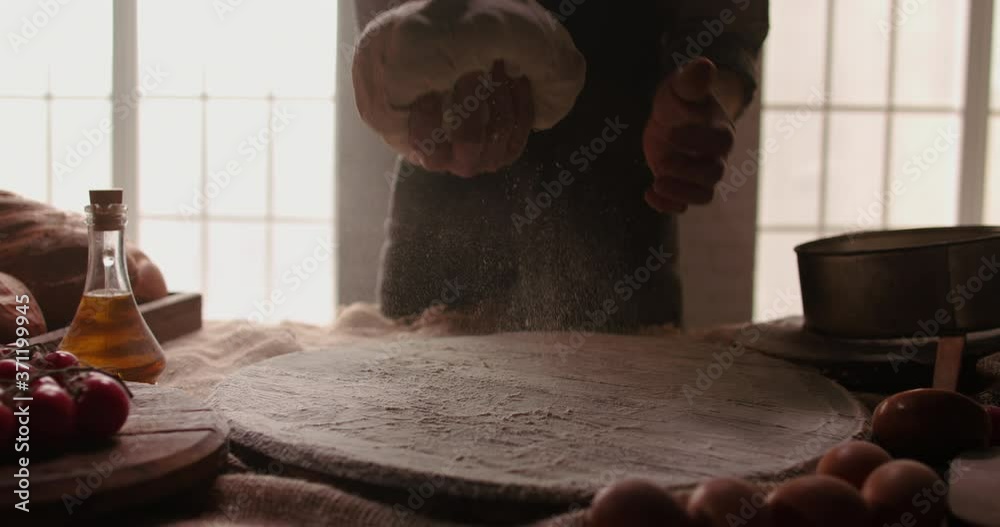 Closeup shot of hands of mature chef working in bakery shop kneading dough for bread with his traditional techniques and recipe 4k footage