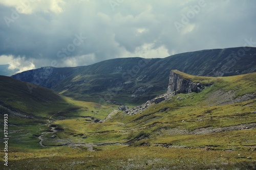 rocky mountains with green grass in summer