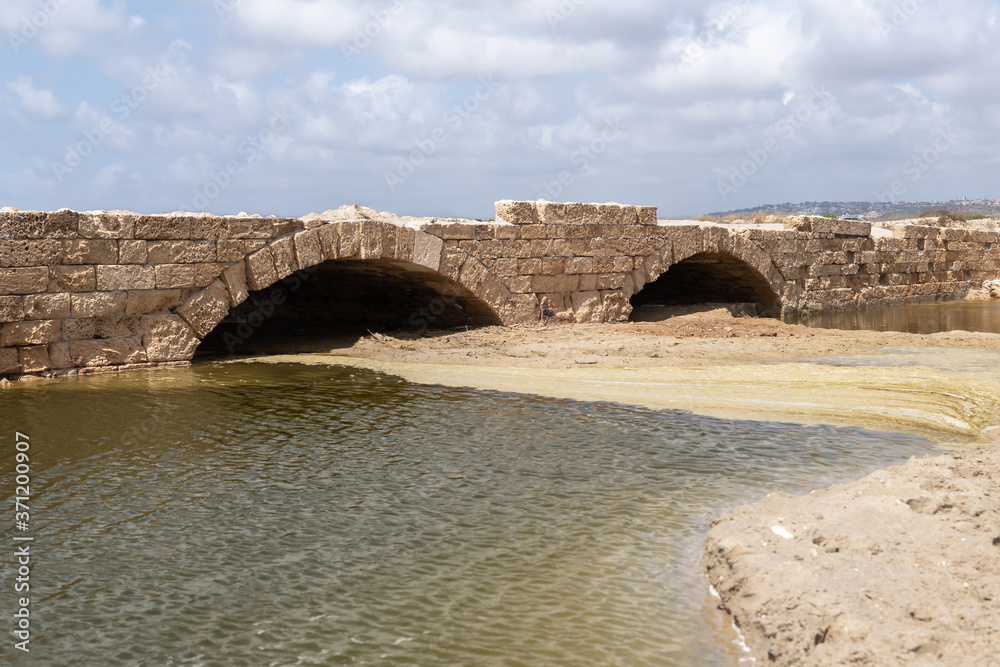 Remains  of a bridge across Nahal Taninim River - Crocodile River near ruins of Turris Slinarum - Salt Tower fortress near to Jisr Ez Zarqa arab village. Located near the Atlit city in northern Israel