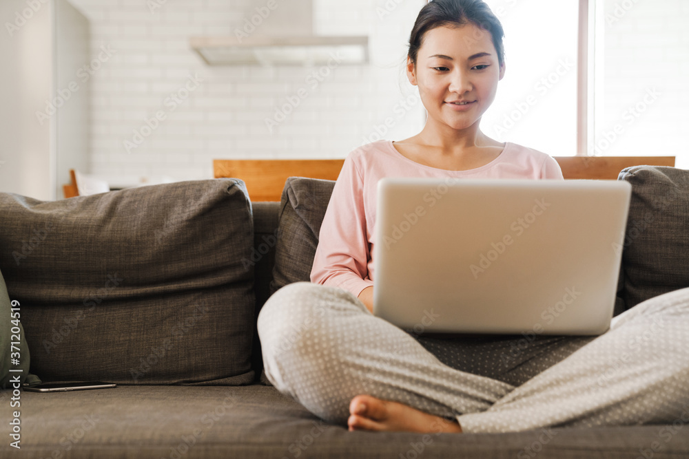 Fototapeta premium Attractive young asian woman using laptop computer