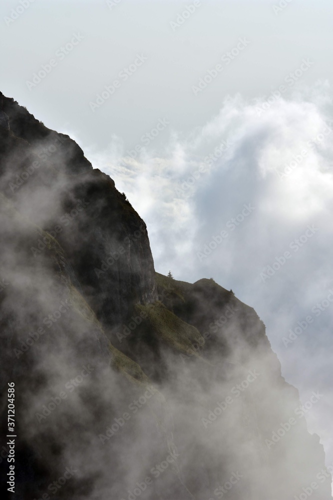fluffy white clouds among the mountain ridges. mist at high altitude