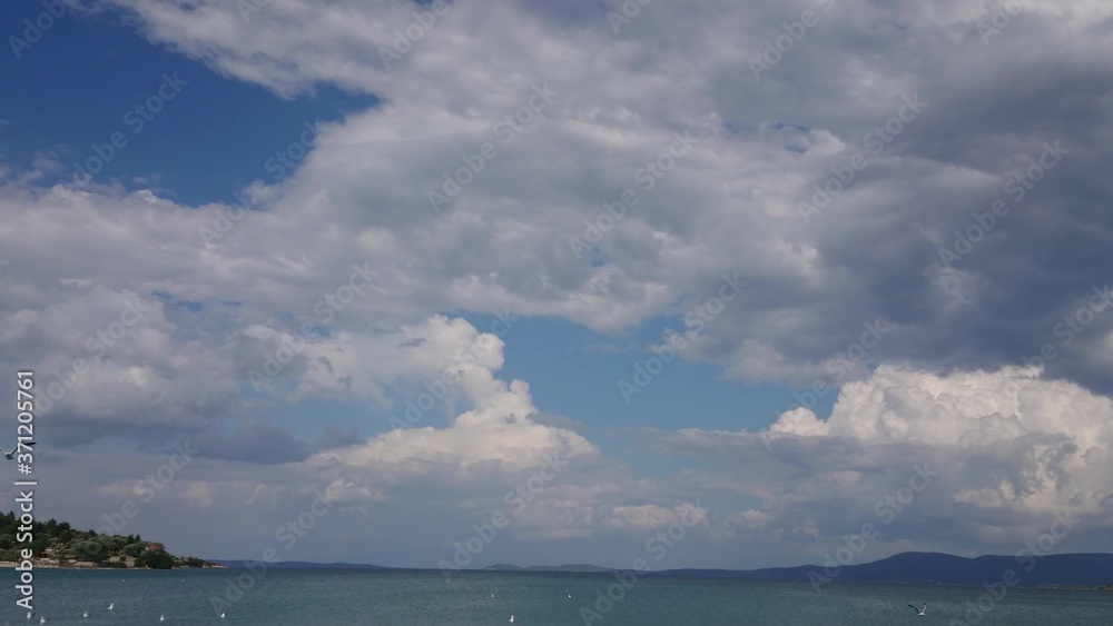 Nature landscape with sea, clouds and seagull fly in the sky over the sea at Urla, Izmir.