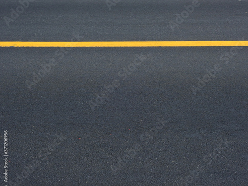 dark asphalt road with yellow line of lane © srckomkrit