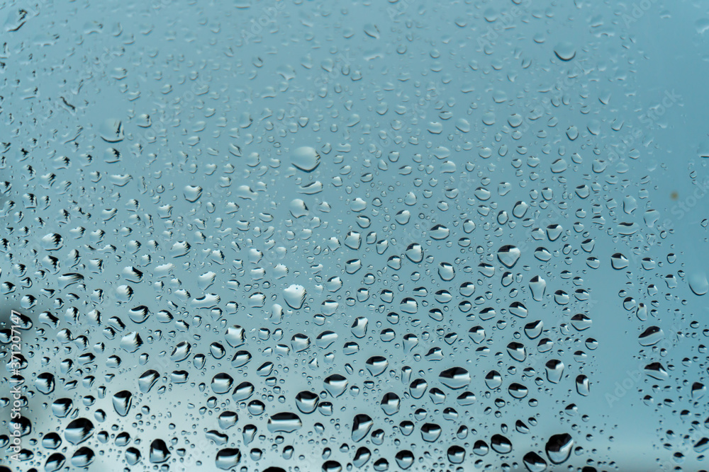 Macro raindrops vapor on window glass. Rain drops on window glasses surface. Through the window view. Drops of rain on glass. Water pattern texture Macro raindrops vapor on window glass. Rain drops on window glasses surface. Through the window view. Drops of rain on glass. Water pattern texture