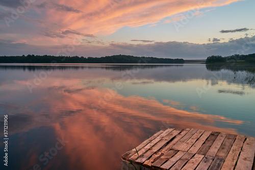 Fototapeta Naklejka Na Ścianę i Meble -  Pier by the lake and sunset