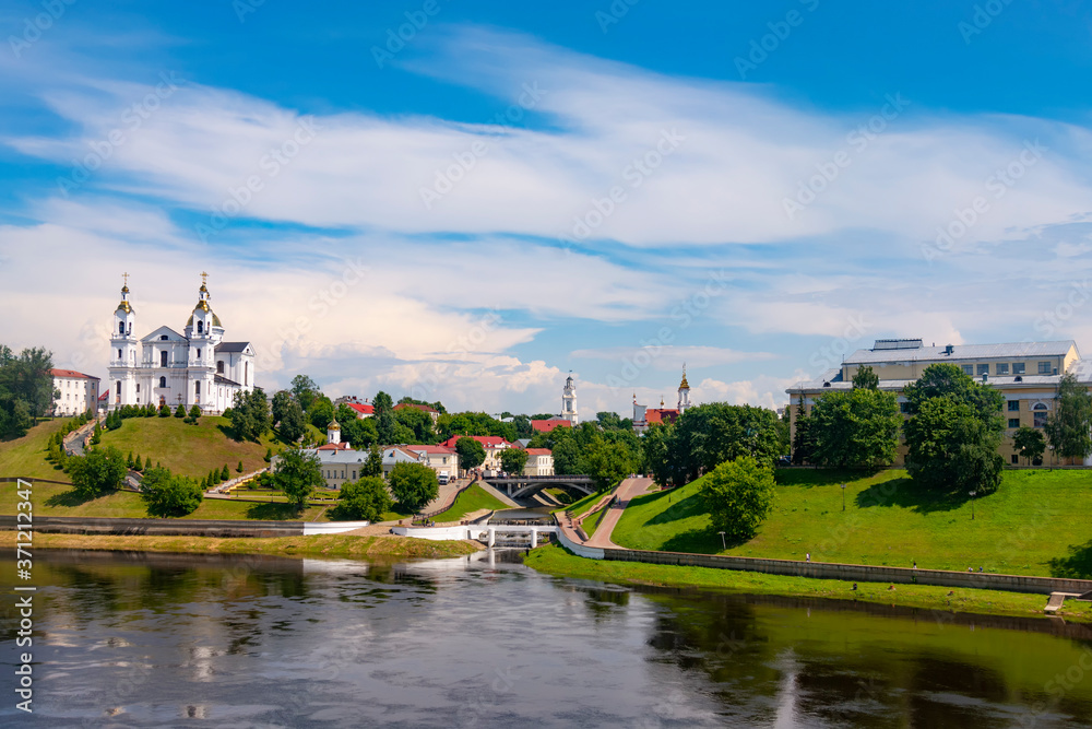Vitebsk,Belarus - 21 July 2020 : Holy Assumption Cathedral of the Assumption on the hill and the Holy Spirit convent and Scenic view of beautiful blue sky with fluffy white clouds. Vitebsk, Belarus