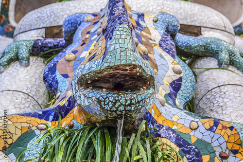 Colorful ceramic Dragon salamandra in Park Guell. Park Guell is the famous architectural town art designed by Antoni Gaudi. Barcelona, Spain.