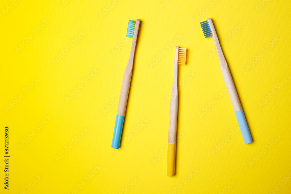 bright toothbrushes on a yellow background bright toothbrushes on a yellow background