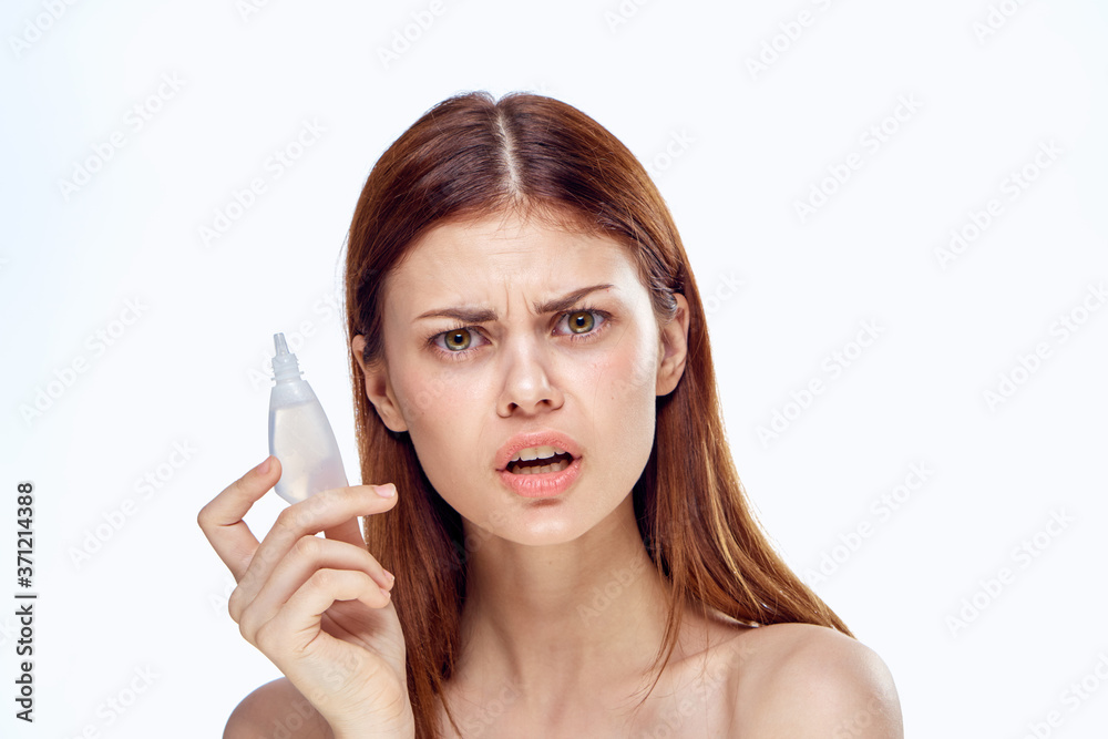 Woman holding eye drops in her hands a medicine for health lifestyle light background. Woman holding eye drops in her hands a medicine for health lifestyle light background.