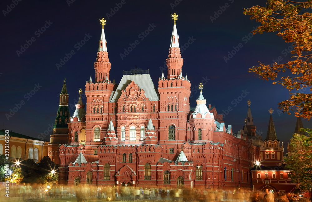 Huge red castle like building enlightened at night. State Historical Museum at Red Square, Moscow, Russia