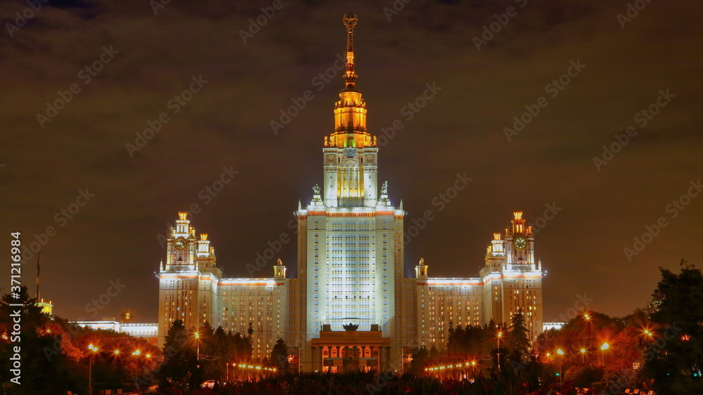 Fototapeta premium Front view of monumental enlightened Lomonosov university in Moscow, Russia at night