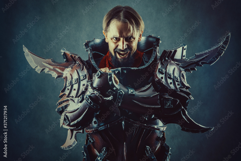 Powerful knight in the armor. Dark background. Powerful knight in the armor. Dark background.
