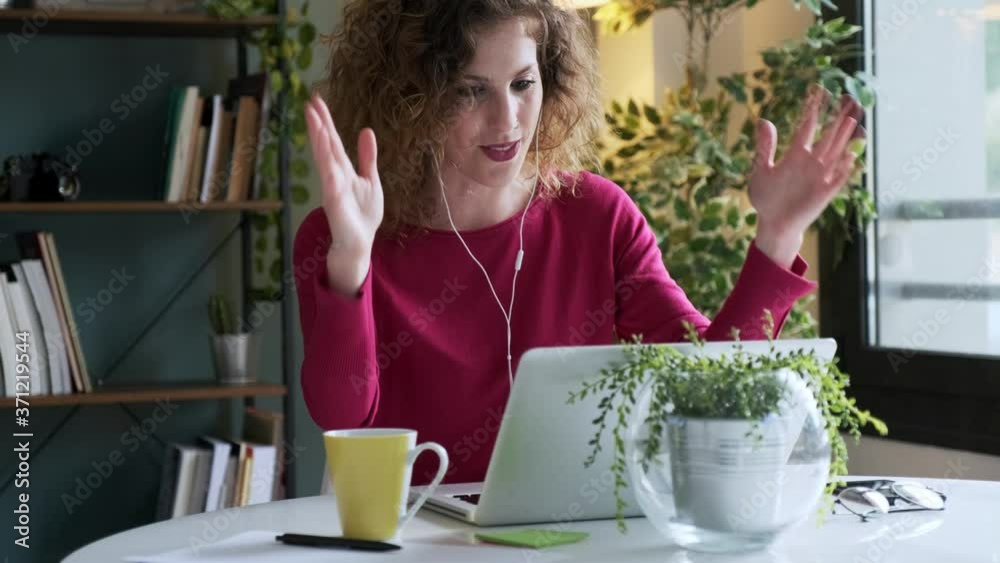 Businesswoman using laptop for video call at home Businesswoman using laptop for video call at home